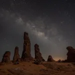 Star-filled night sky above AlUla rock formations