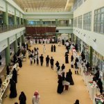 Arts and heritage booths with visitors at the University of Tabuk youth culture and arts forum